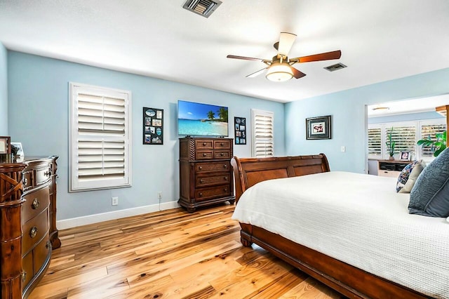 bedroom with a ceiling fan, baseboards, visible vents, and light wood finished floors