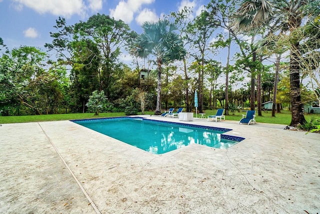 outdoor pool with a patio area