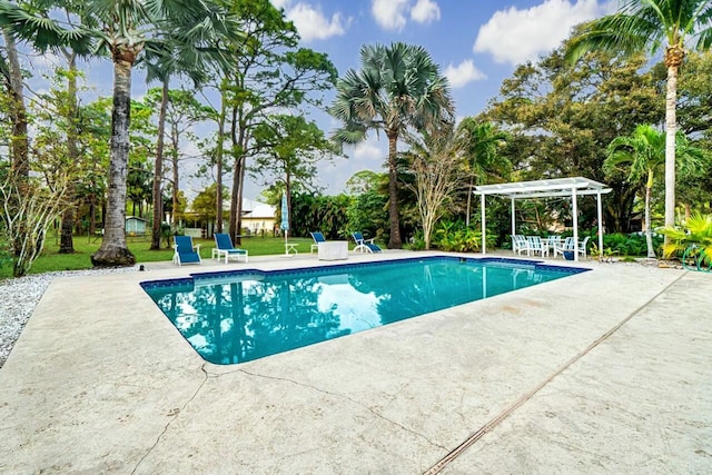 outdoor pool with a patio and a pergola