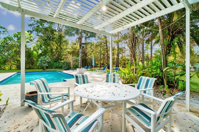 view of patio / terrace with an outdoor pool and a pergola