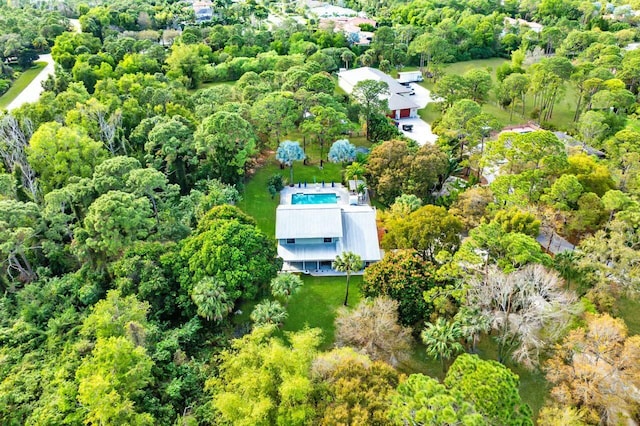 birds eye view of property with a wooded view