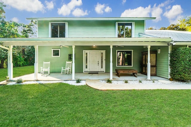 rear view of property featuring a yard