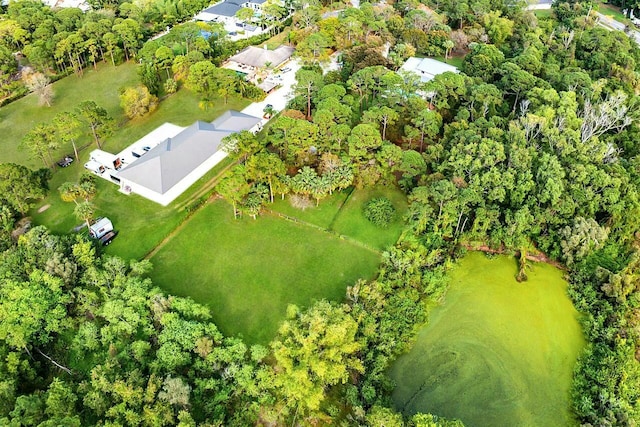 drone / aerial view with a wooded view