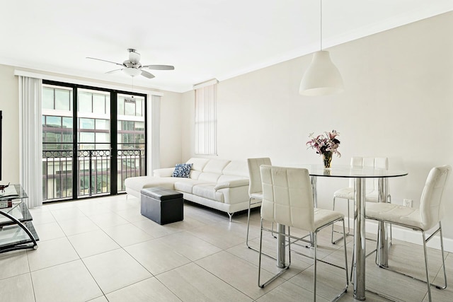 living room with light tile patterned floors, ornamental molding, and ceiling fan