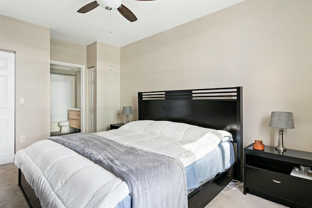 bedroom featuring ensuite bathroom, carpet, and ceiling fan