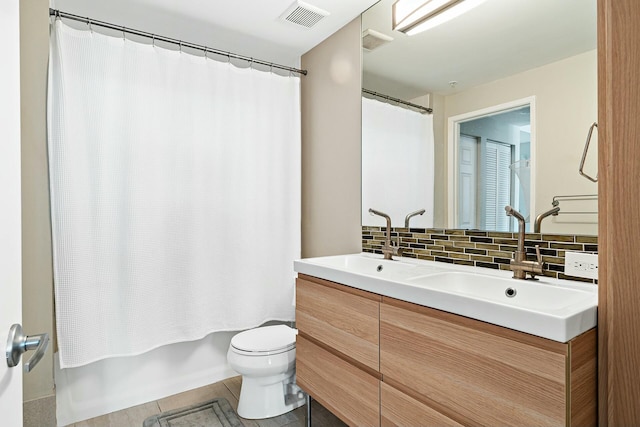 full bathroom featuring decorative backsplash, vanity, toilet, shower / bath combo, and tile patterned floors