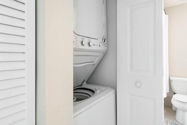 washroom with stacked washer and clothes dryer