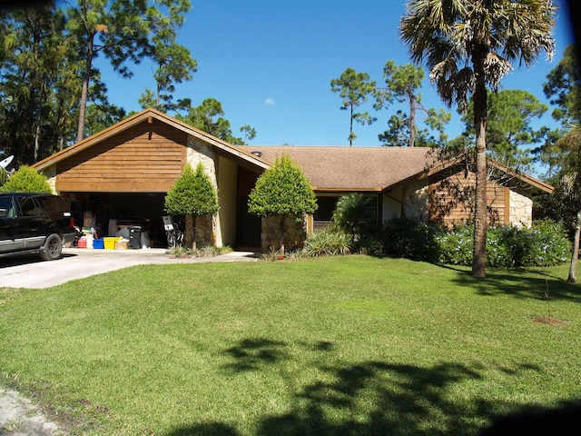 ranch-style house with a garage and a front lawn