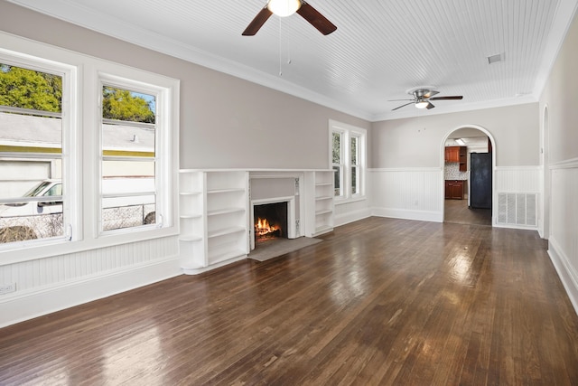 unfurnished living room featuring dark wood-style flooring, a fireplace with flush hearth, and visible vents