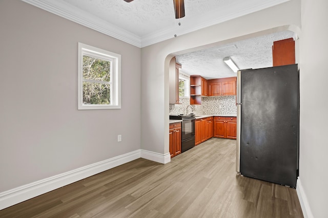 kitchen featuring stove, light countertops, freestanding refrigerator, open shelves, and light wood finished floors