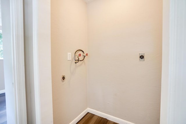 laundry room featuring baseboards, laundry area, wood finished floors, and hookup for an electric dryer