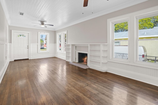 unfurnished living room with a fireplace with flush hearth, visible vents, ceiling fan, ornamental molding, and dark wood-type flooring