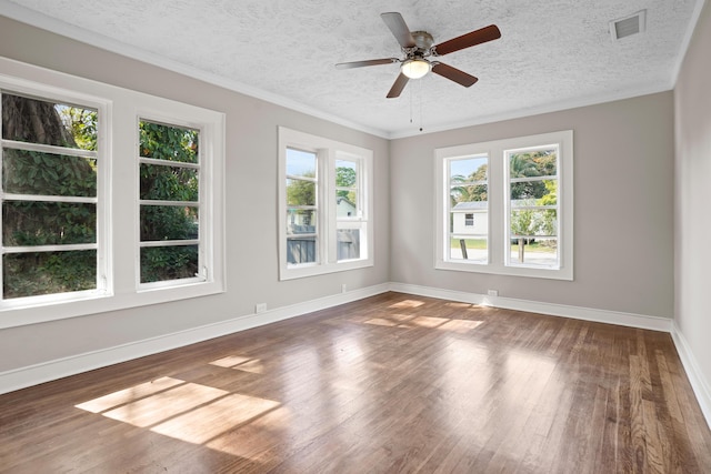 unfurnished room featuring a textured ceiling, dark wood finished floors, visible vents, and baseboards