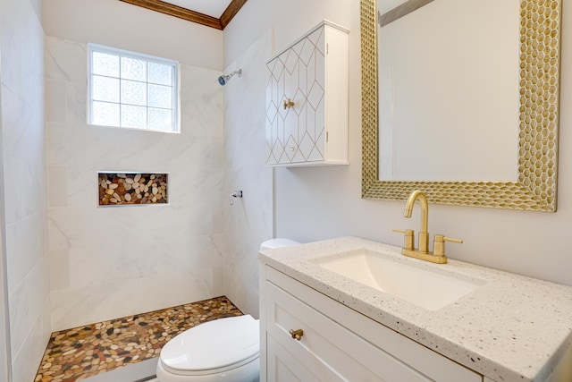 bathroom with a shower stall, crown molding, vanity, and toilet