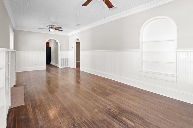 unfurnished living room with dark wood-type flooring, ornamental molding, and ceiling fan