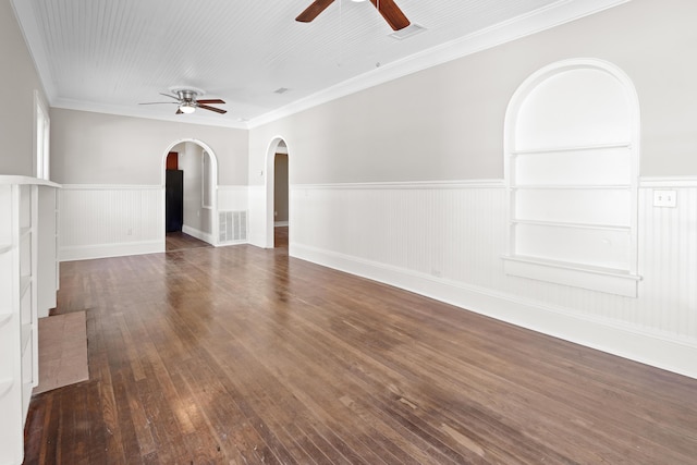 spare room with dark wood-style floors, arched walkways, visible vents, and a ceiling fan