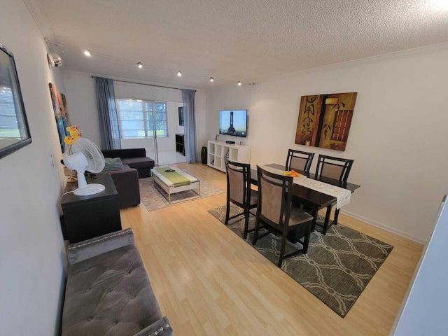 dining area with hardwood / wood-style floors and a textured ceiling