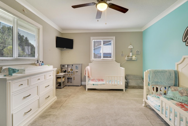 bedroom featuring light colored carpet, ornamental molding, and ceiling fan