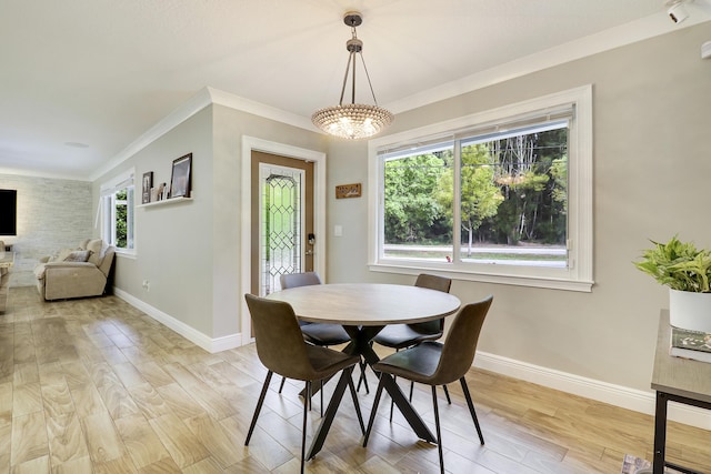 dining area featuring ornamental molding, plenty of natural light, and light hardwood / wood-style floors