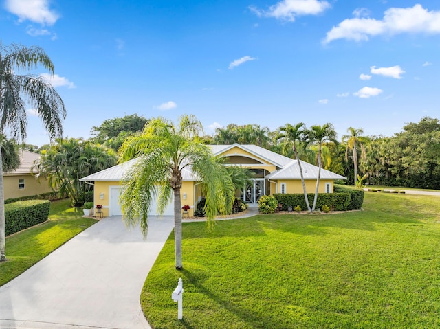 single story home featuring a garage and a front yard