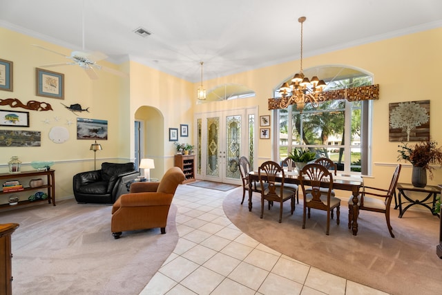 carpeted dining room featuring a high ceiling, ornamental molding, a wealth of natural light, and french doors