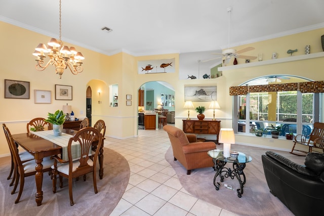 tiled dining space with a high ceiling, crown molding, and ceiling fan with notable chandelier