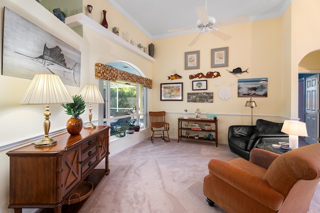 sitting room with ornamental molding, carpet floors, and ceiling fan