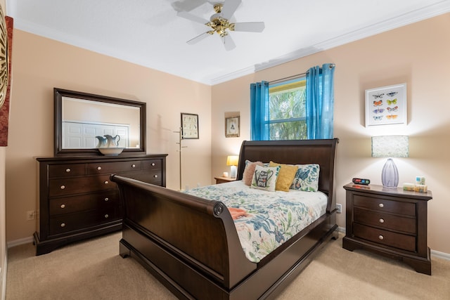 bedroom with crown molding, light colored carpet, and ceiling fan