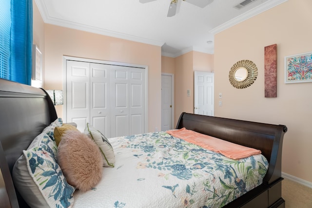 carpeted bedroom with ornamental molding, a closet, and ceiling fan