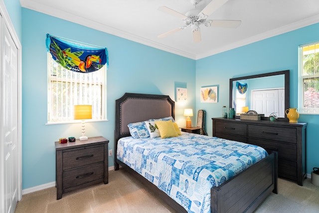 carpeted bedroom with crown molding and ceiling fan