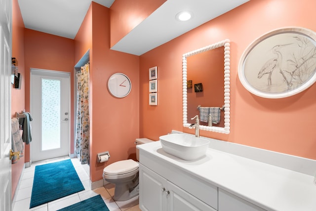 bathroom featuring a shower with curtain, vanity, toilet, and tile patterned flooring