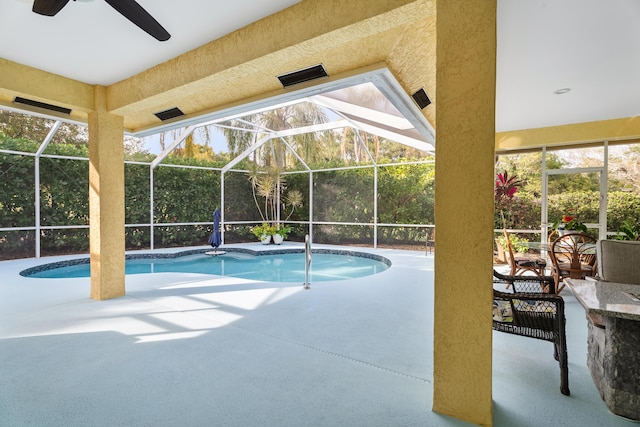 view of pool featuring a patio area and glass enclosure