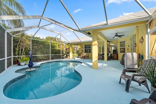 view of swimming pool featuring a lanai, a patio, and ceiling fan