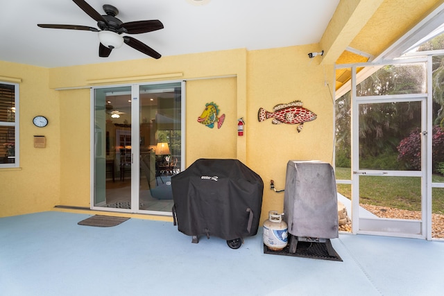 sunroom / solarium featuring ceiling fan