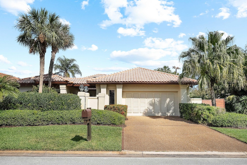 mediterranean / spanish-style house with a garage