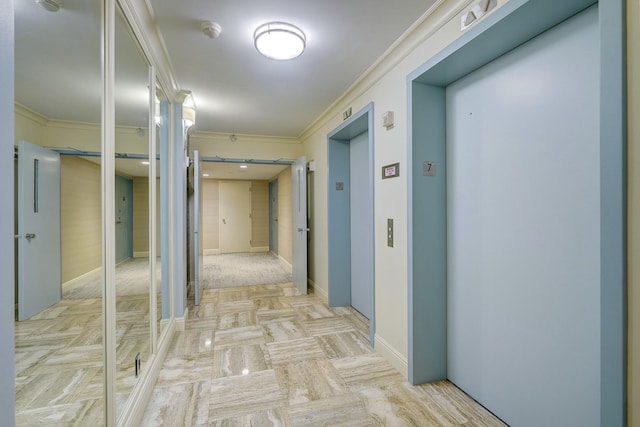 corridor featuring crown molding, baseboards, and elevator