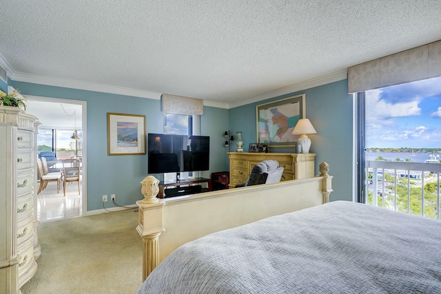 bedroom featuring a textured ceiling, ornamental molding, and carpet flooring