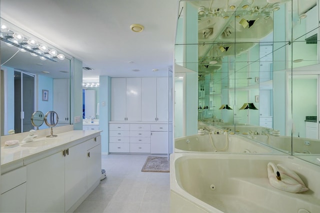 full bath with a jetted tub, tile patterned flooring, visible vents, and vanity