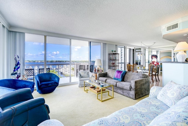 living area featuring a textured ceiling, a wall of windows, visible vents, and light colored carpet