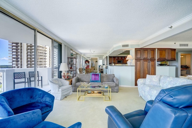 living room with light carpet, ornamental molding, a textured ceiling, and visible vents