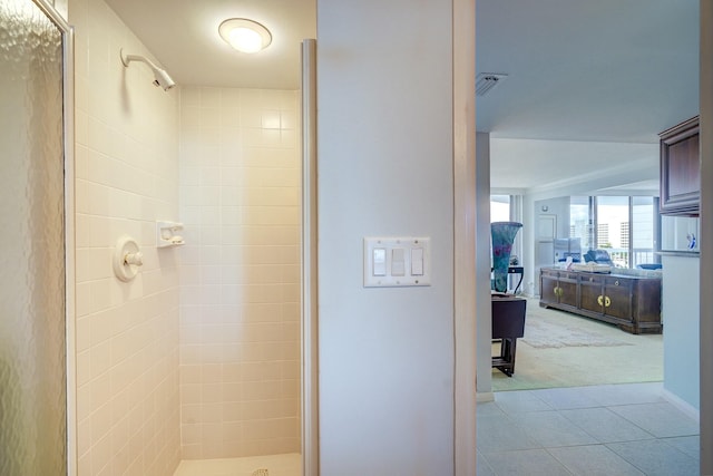 full bathroom featuring tile patterned flooring, visible vents, and a shower stall