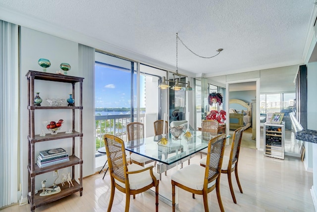 dining area with a healthy amount of sunlight, beverage cooler, and a wall of windows