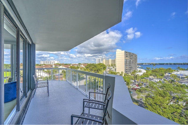 balcony featuring a view of city and a water view