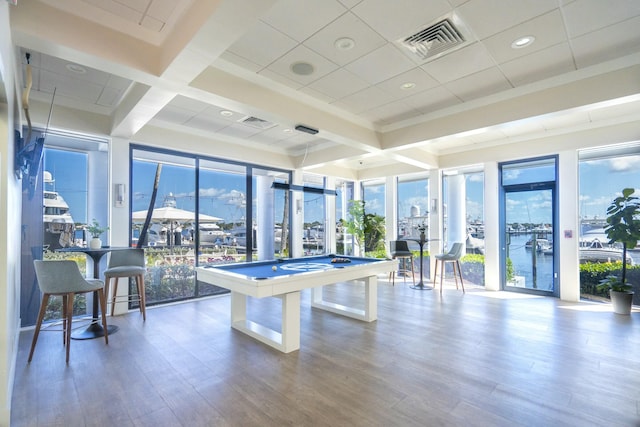 playroom with billiards, a water view, wood finished floors, and visible vents