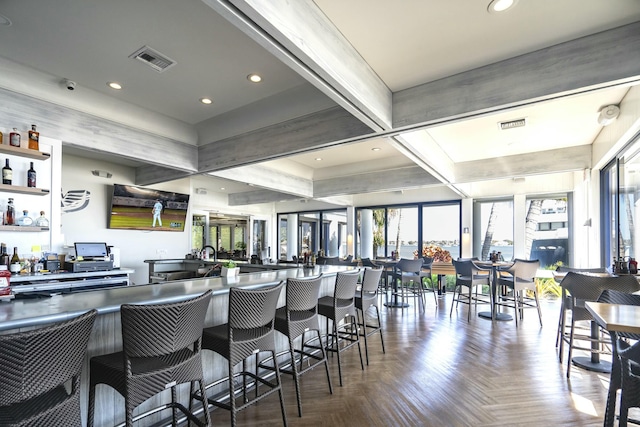 bar with coffered ceiling, recessed lighting, visible vents, and beamed ceiling