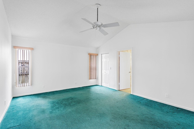 spare room featuring a textured ceiling, vaulted ceiling, ceiling fan, and carpet