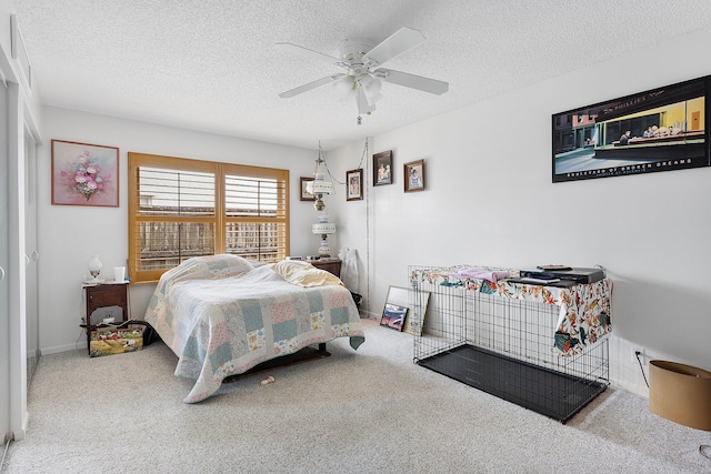 carpeted bedroom with ceiling fan and a textured ceiling