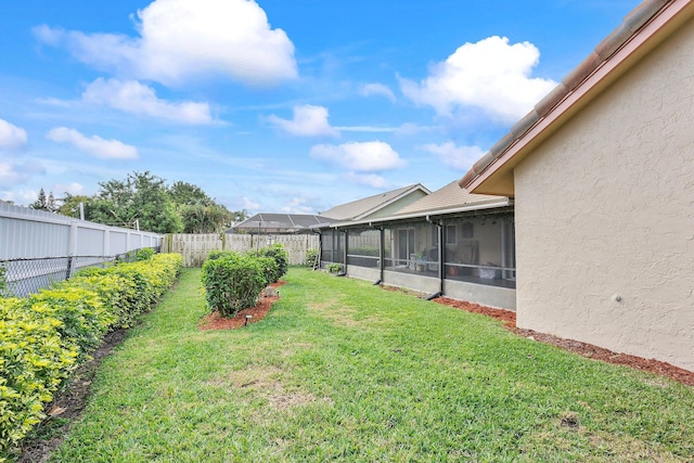 view of yard with a sunroom