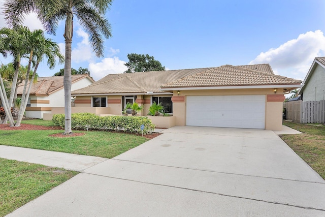 view of front of property featuring a garage and a front yard