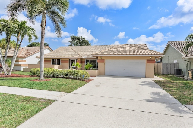 view of front of property featuring a garage, central AC, and a front yard